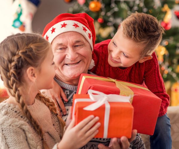 children giving gifts to grandfather