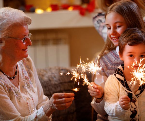 Grandmother and grandchildren enjoying sparklers